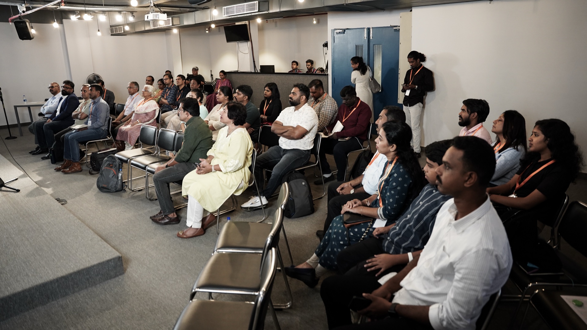 The audience attending a Joy Corp business conference session