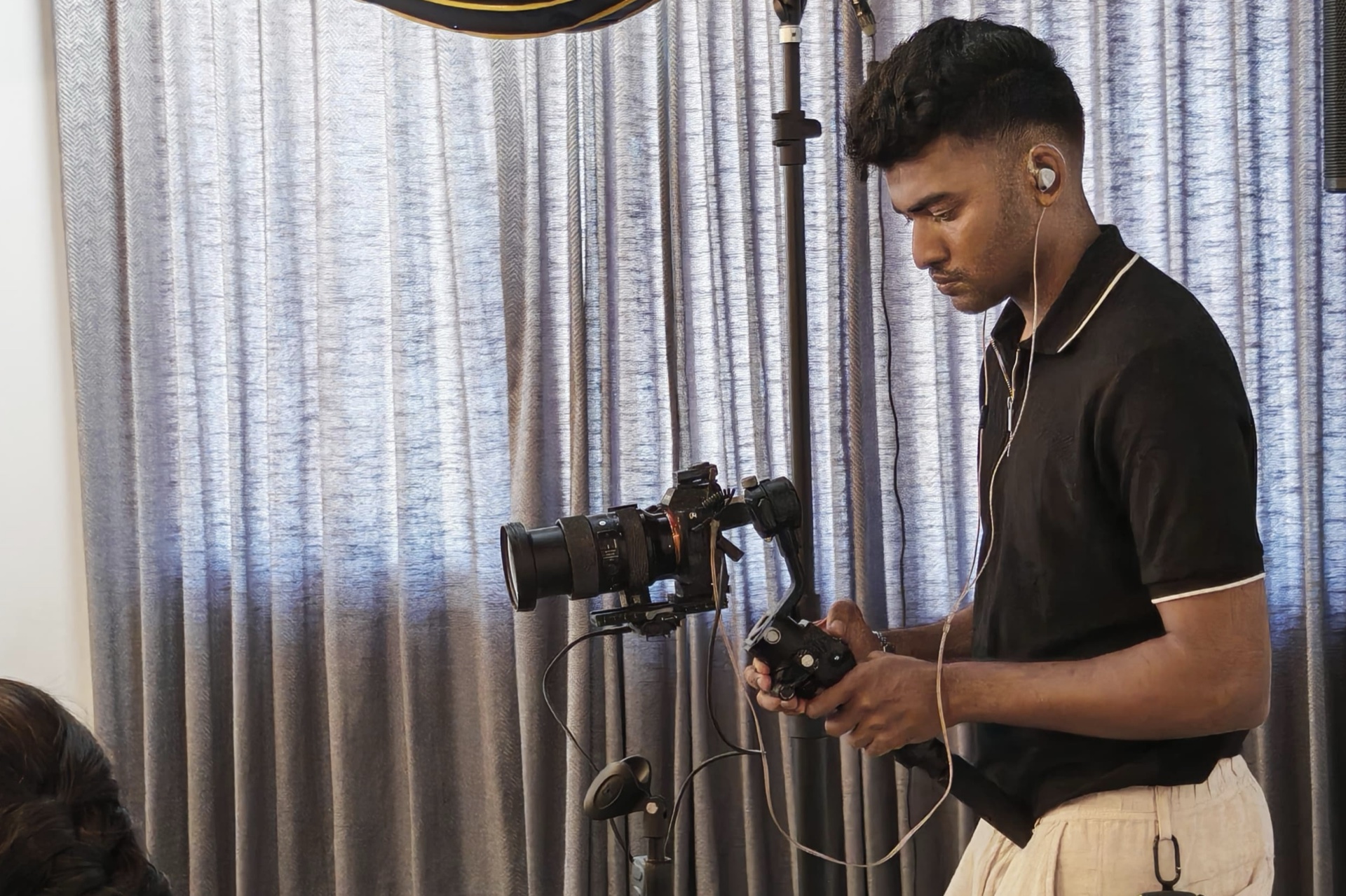 Alin operating a gimbal camera during the Joy Corp production